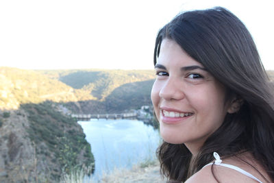 Portrait of smiling woman against mountains at miranda do douro