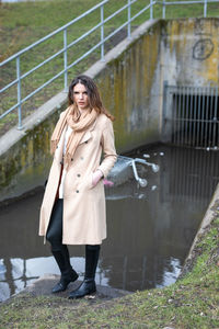 Full length of woman standing near water