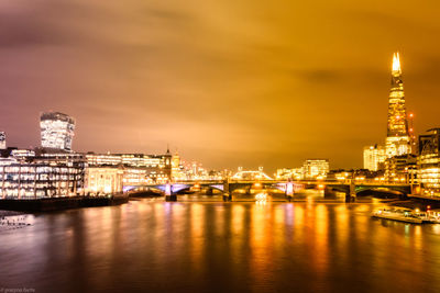 Illuminated city at waterfront