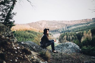 Rear view of woman looking at mountain landscape