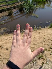 Midsection of person hand on water