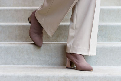 Low section of woman standing on concrete floor