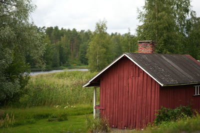 House on field against trees