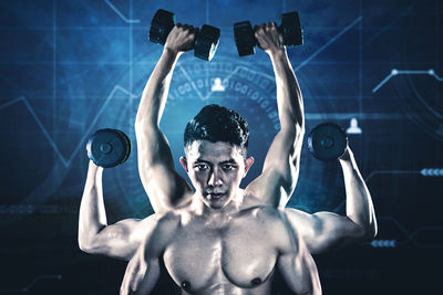 Portrait of young man with arms outstretched