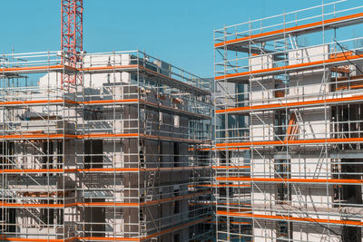 Buildings under construction against clear sky