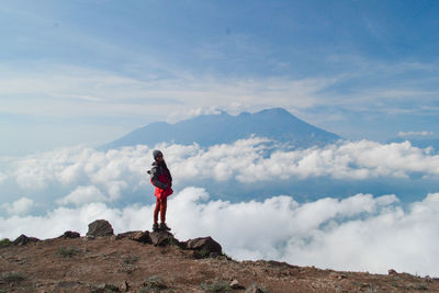 Man standing on mountain against sky