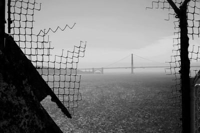 Low angle view of fence against sky