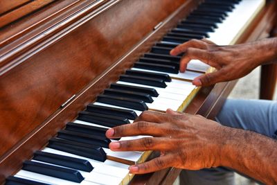 Midsection of man playing piano