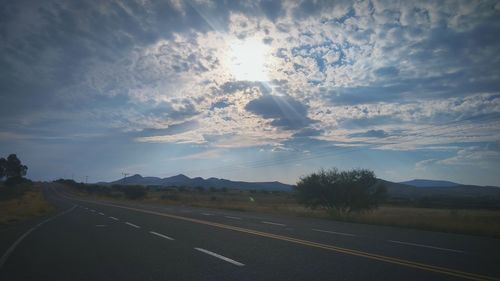 Road by landscape against sky