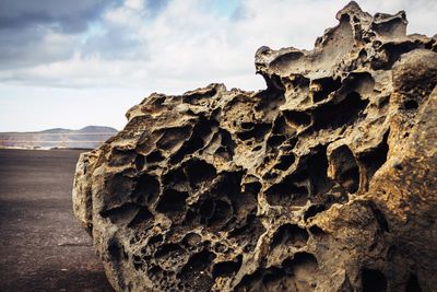 Rock formations against cloudy sky