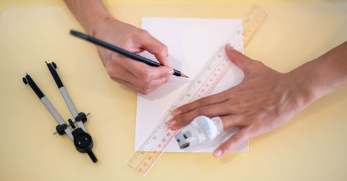 Cropped hands of person working on table