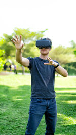 Man wearing virtual reality simulator while gesturing on field