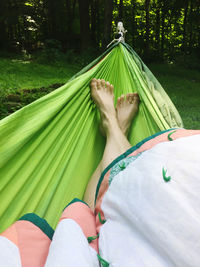 Low section of woman relaxing on hammock