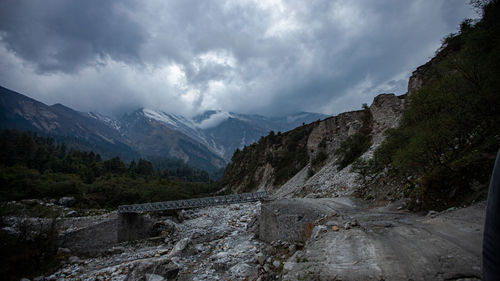 Scenic view of mountains against cloudy sky