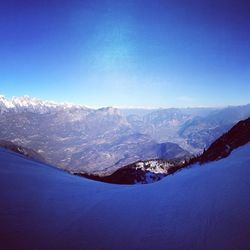 Scenic view of mountains against clear blue sky