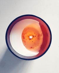 Directly above shot of eggs in bowl against white background