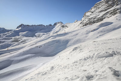 Scenic view of snowcapped mountains against clear sky