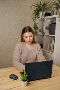 Student girl learning online having video call via laptop computer