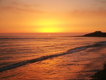 Scenic view of sea against orange sky