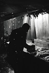 Rear view of woman working at food