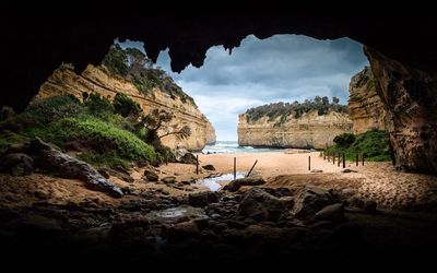 Scenic view of sea seen through cave