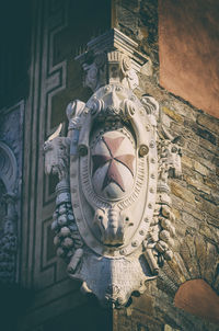 Low angle view of sculpture on wall of building