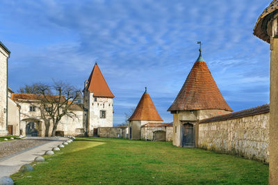 Temple by building against sky