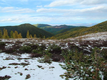 Scenic view of landscape and mountains against sky
