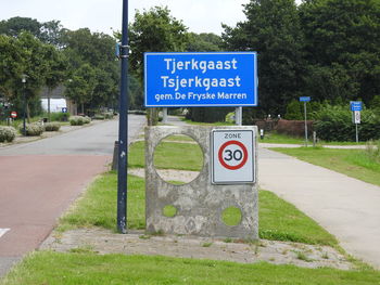 Road sign by trees