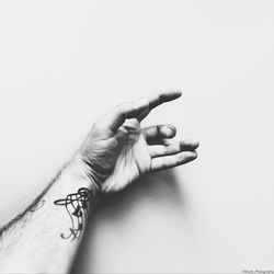 Close-up of hand against white background