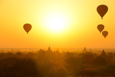 Hot air balloons in sky at sunset