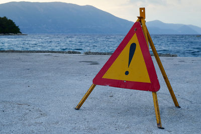 Close-up of warning sign on beach