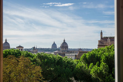 Distant view of st peters basilica in city seen through window