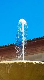 Low angle view of bubbles against clear blue sky