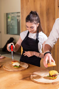 Young woman preparing food at home