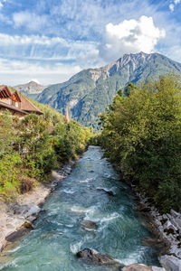 Scenic view of river amidst mountains against sky