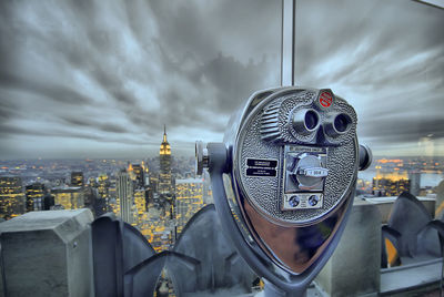 View of cityscape against cloudy sky