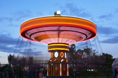 Low angle view of ferris wheel against blue sky