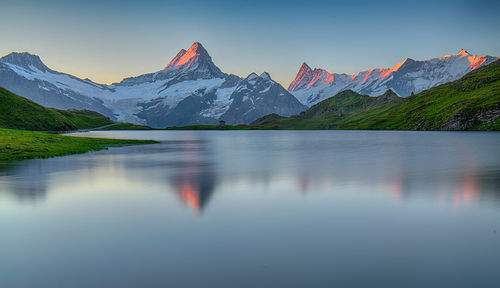 Scenic view of lake and mountains against sky