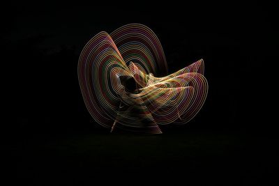 Illuminated light painting against black background