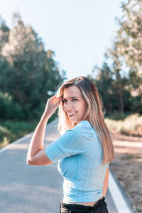 Portrait of smiling young woman standing outdoors