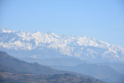 Scenic view of snowcapped mountains against clear sky