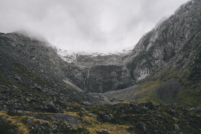 Low angle view of waterfalls at milford sound, foggy and rainy day, nz