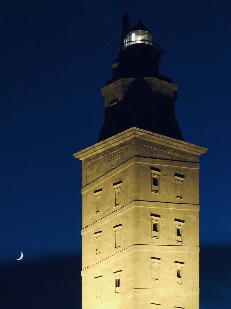 LOW ANGLE VIEW OF ILLUMINATED BUILDING AGAINST CLEAR SKY