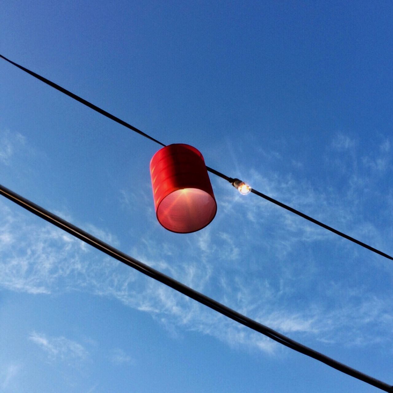 low angle view, sky, blue, cable, hanging, lighting equipment, power line, red, electricity, street light, pole, balloon, connection, cloud - sky, power cable, outdoors, no people, lantern, cloud, day