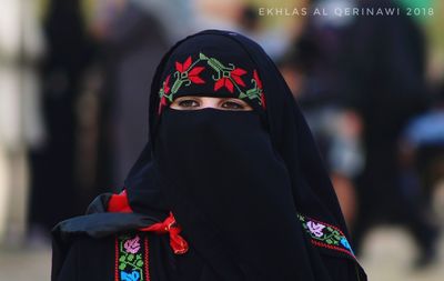 Close-up portrait of woman wearing mask