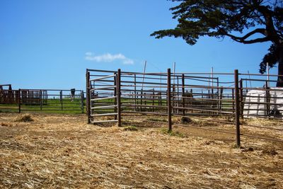 Fence on field against sky