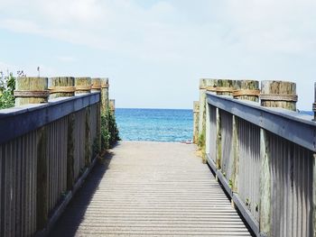 Pier over sea against sky