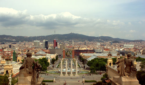 Cityscape against cloudy sky