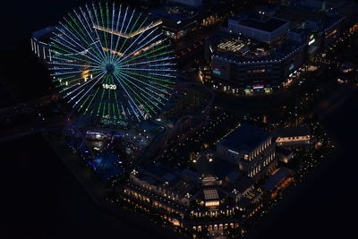 High angle view of illuminated ferris wheel at night